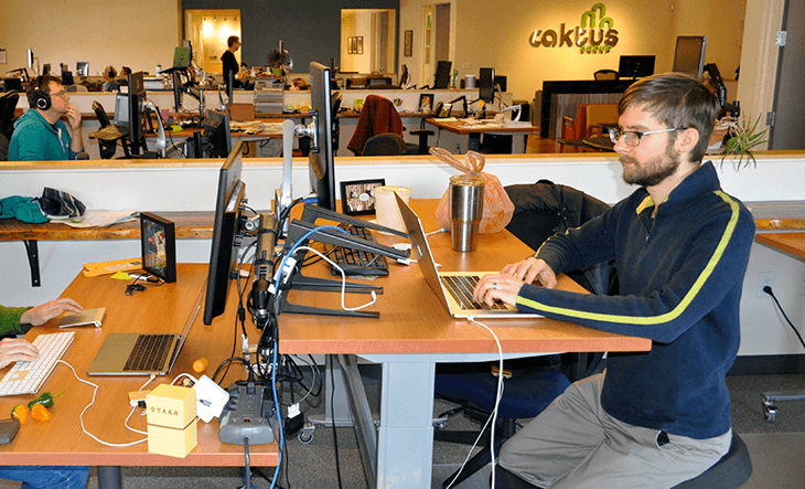Developer and blog author Dmitriy Chukhin codes at his desk in the Caktus office