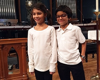 Developer Vinod Kurup’s daughter and niece, who are members of the Sisters' Voices choir.